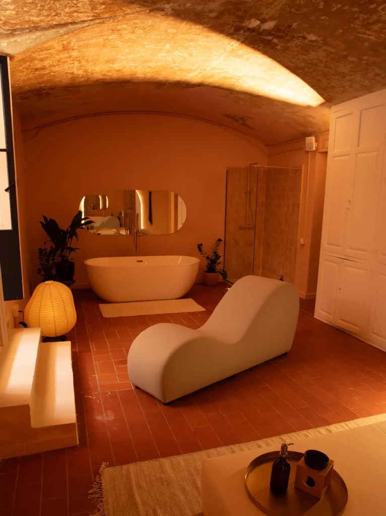 Suite de Bliss con bañera exenta, sillón tantra, tatami y luz cálida en ambiente íntimo y sofisticado